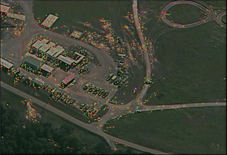 Figure 1: Feature tracking results for kwiver_fmv_set_1. The green points show feature tracks on this frame, and the red curves show feature motion over recent history.
