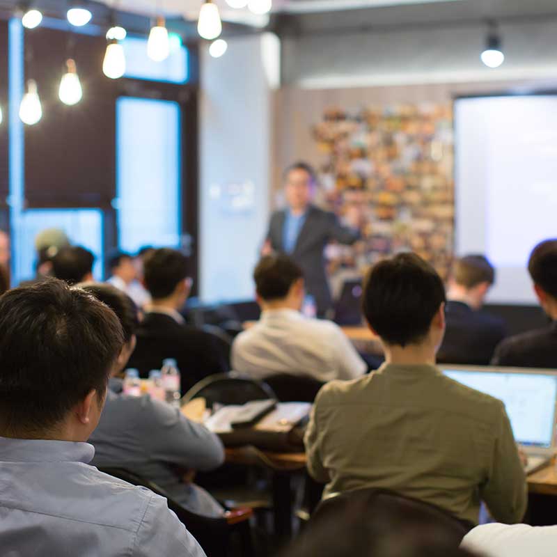 Person presenting in front of students.