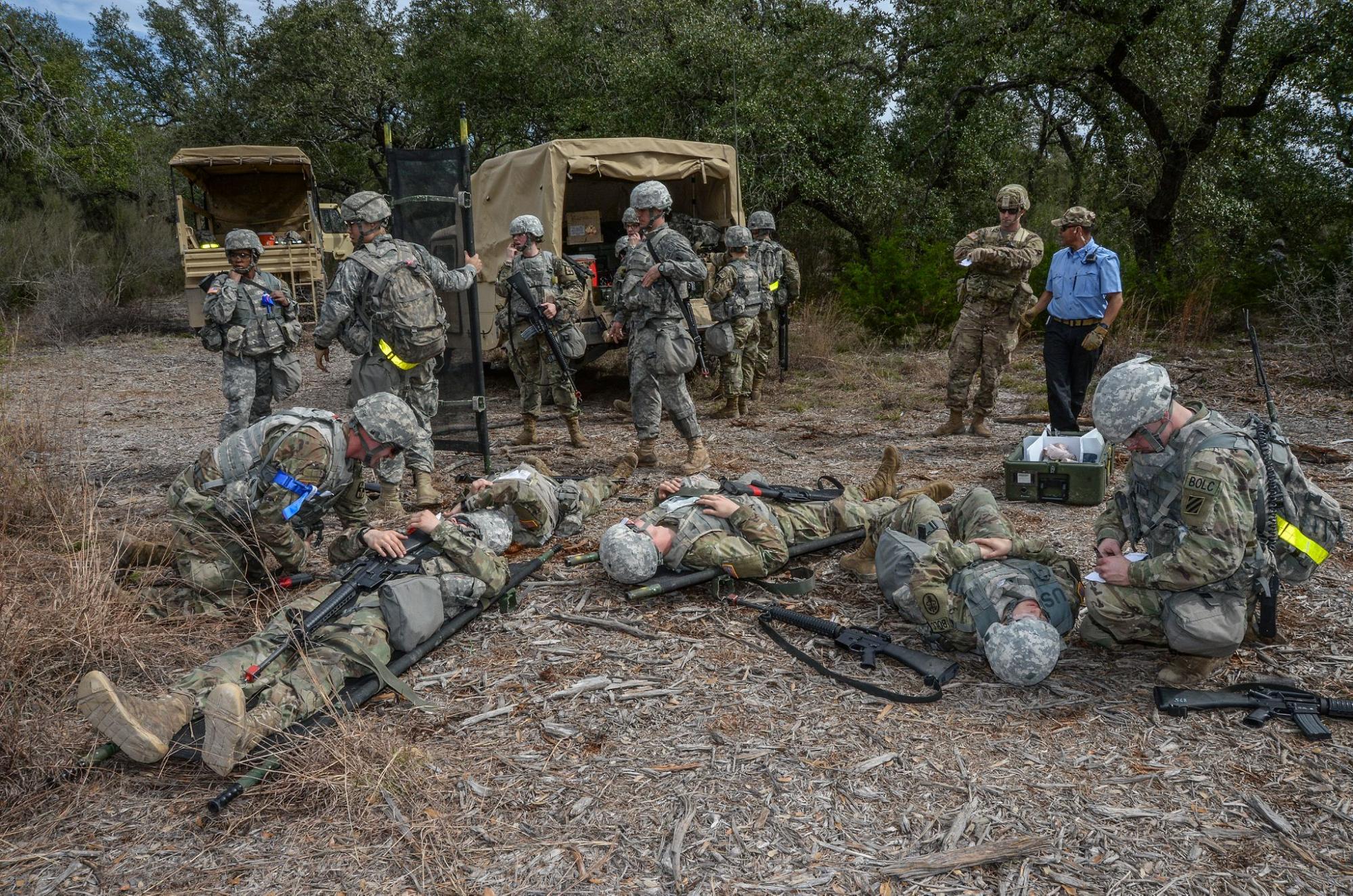 During a training exercise, soldiers take care of wounded soldiers while others unload a truck. U.S. Air Force photo by Johnny Saldivar courtesy of DVIDS