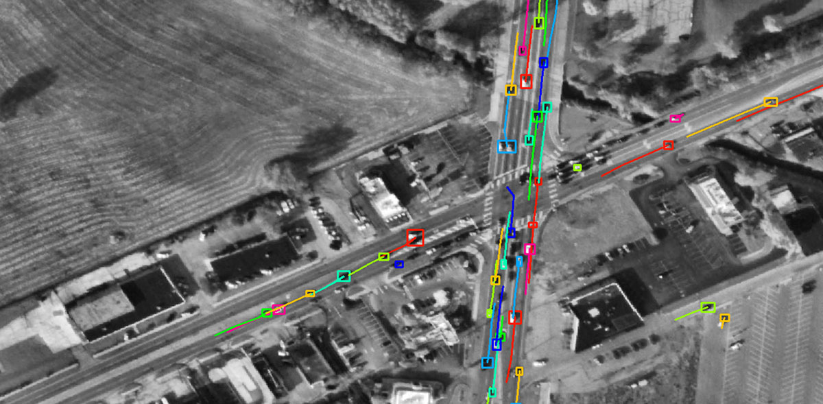 Satellite view of intersecting roads with cars highlighted.