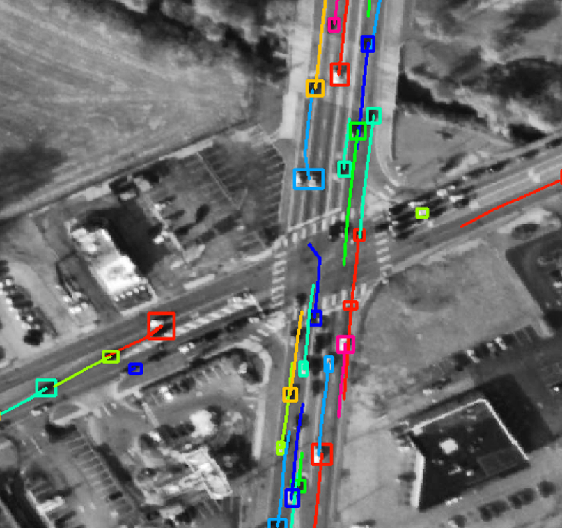 satellite image of a road with cars highlighted.