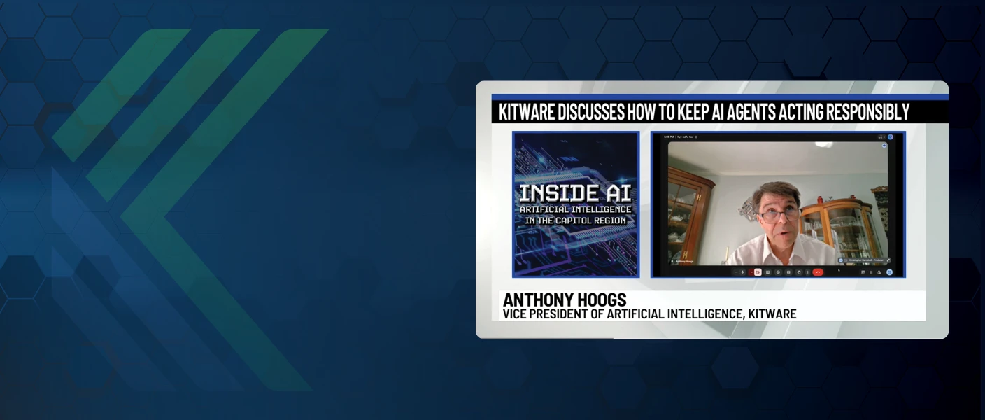 A website hero banner featuring Kitware branding alongside a broadcast frame titled "KITWARE DISCUSSES HOW TO KEEP AI AGENTS ACTING RESPONSIBLY," showcasing Anthony Hoogs, Vice President of Artificial Intelligence.