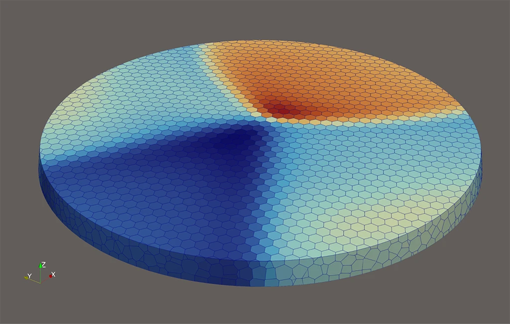 A ParaView 3D visualization of a cylindrical disk with a fine polygonal mesh, color-coded with a blue-to-red temperature or scalar field gradient.